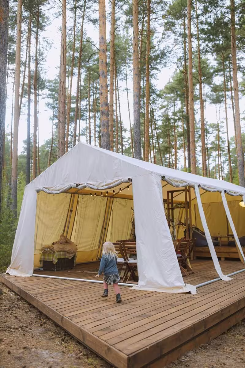 Interior lounge area of The Fox tent with layered textiles