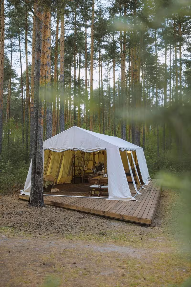 The Fox safari tent deck at golden hour with countryside views